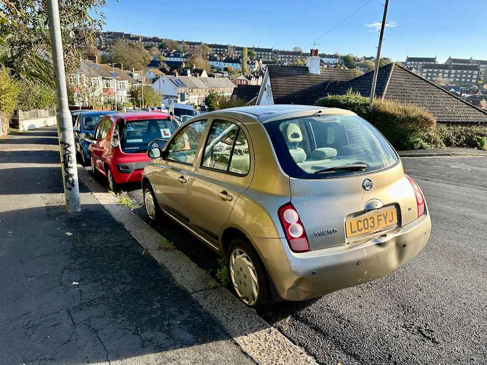 Photograph of LC03 FYJ - a Gold Nissan Micra parked in Hollingdean by a non-resident, and potentially abandoned. The eighth of twenty-eight photographs supplied by the residents of Hollingdean.