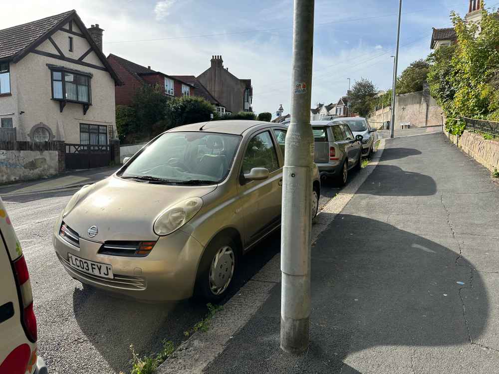 Photograph of LC03 FYJ - a Gold Nissan Micra parked in Hollingdean by a non-resident, and potentially abandoned. The sixth of twenty-three photographs supplied by the residents of Hollingdean.