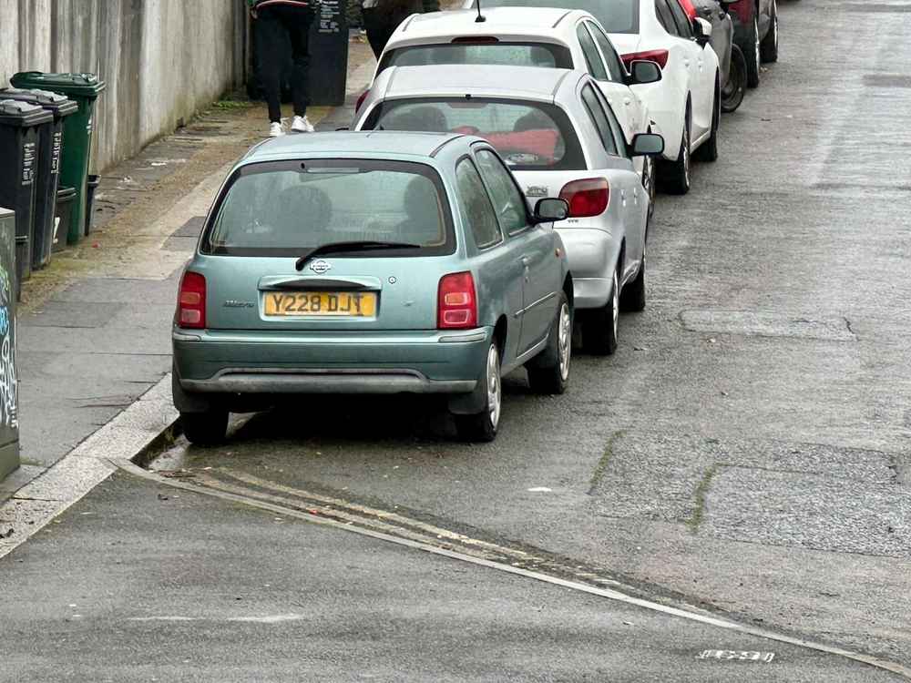 Photograph of Y228 DJT - a Green Nissan Micra parked in Hollingdean by a non-resident, and potentially abandoned. The first of nine photographs supplied by the residents of Hollingdean.