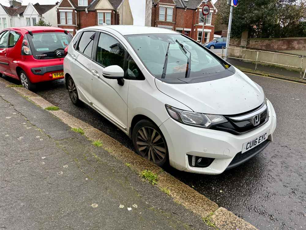 Photograph of CU16 EYC - a White Honda Jazz parked in Hollingdean by a non-resident who uses the local area as part of their Brighton commute. The first of four photographs supplied by the residents of Hollingdean.