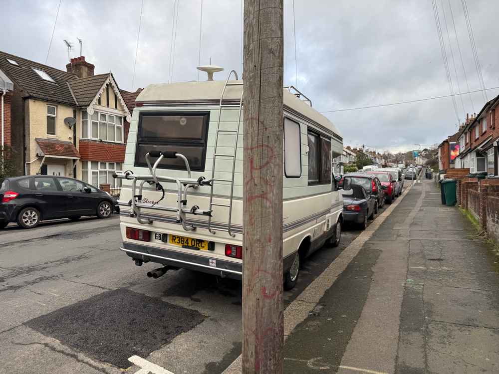 Photograph of R384 ORC - a Beige Volkswagen Transporter camper van parked in Hollingdean by a non-resident, and potentially abandoned. The fifteenth of fifteen photographs supplied by the residents of Hollingdean.