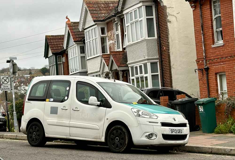 Photograph of SF13 GEU - a White Peugeot Premier taxi parked in Hollingdean by a non-resident, and potentially abandoned. The second of four photographs supplied by the residents of Hollingdean.