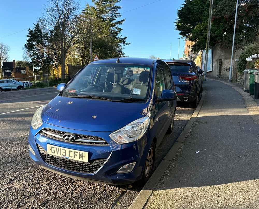 Photograph of GV13 CFM - a Blue Hyundai i10 parked in Hollingdean by a non-resident, and potentially abandoned. The second of two photographs supplied by the residents of Hollingdean.