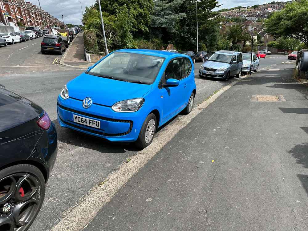 Photograph of YC64 FUU - a Blue VOlkswagen Up parked in Hollingdean by a non-resident. The first of seven photographs supplied by the residents of Hollingdean.