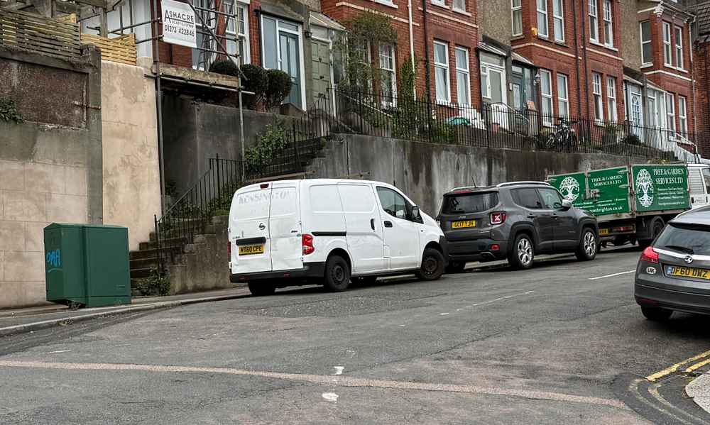 Photograph of MT60 CPE - a White Nissan NV200 parked in Hollingdean by a non-resident, and potentially abandoned. The fourth of four photographs supplied by the residents of Hollingdean.