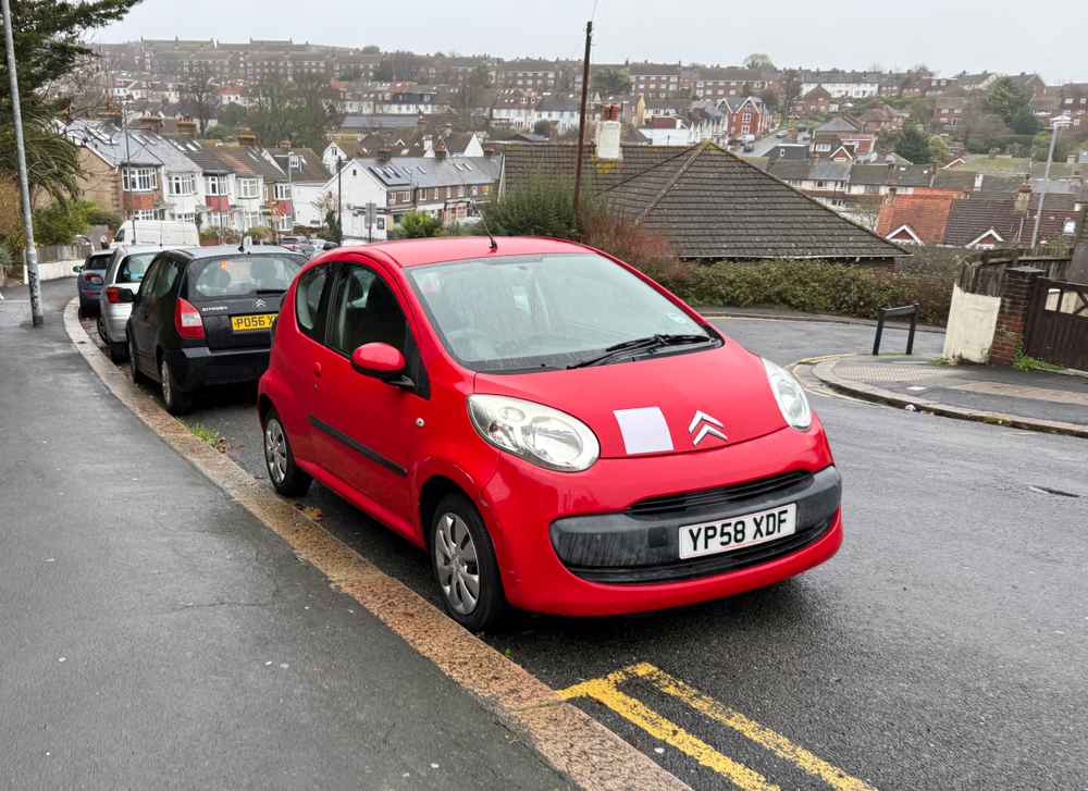 Photograph of YP58 XDF - a Red Citroen C1 parked in Hollingdean by a non-resident, and potentially abandoned. The seventeenth of eighteen photographs supplied by the residents of Hollingdean.