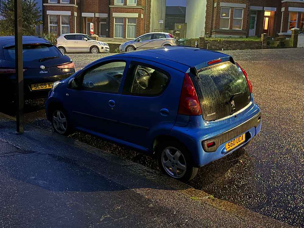 Photograph of LS60 UCA - a Blue Peugeot 107 parked in Hollingdean by a non-resident. The twenty-ninth of thirty photographs supplied by the residents of Hollingdean.