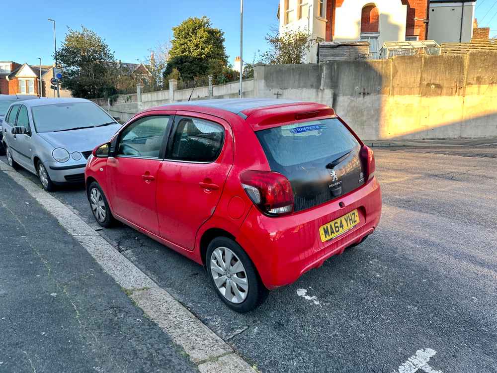 Photograph of MA64 YHZ - a Red Peugeot 108 parked in Hollingdean by a non-resident who uses the local area as part of their Brighton commute. The first of six photographs supplied by the residents of Hollingdean.