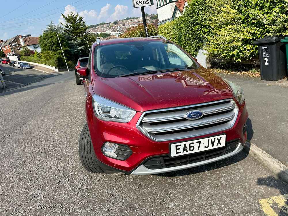 Photograph of EA67 JVX - a Red Ford Kuga parked in Hollingdean by a non-resident. The first of three photographs supplied by the residents of Hollingdean.
