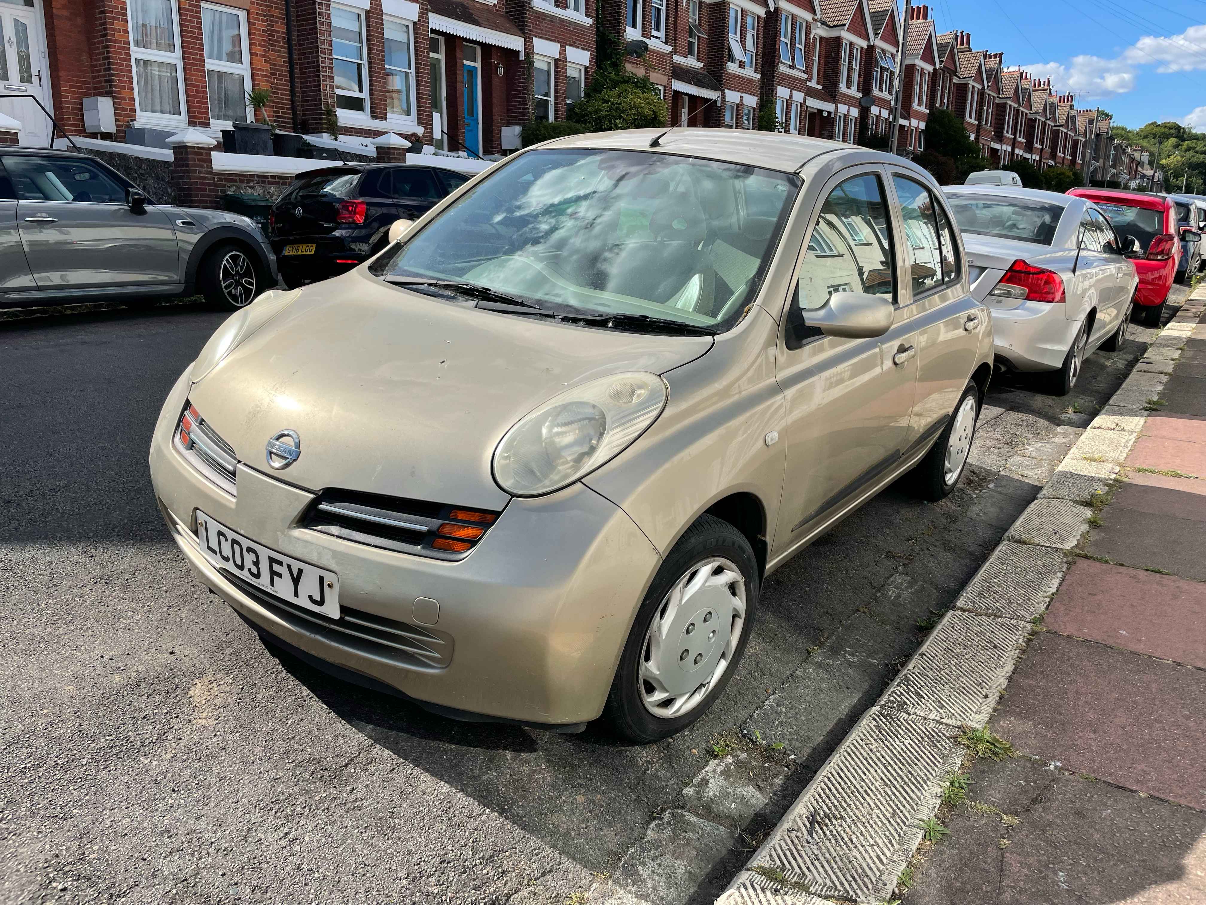 Photograph of LC03 FYJ - a Gold Nissan Micra parked in Hollingdean by a non-resident, and potentially abandoned. The second of seventeen photographs supplied by the residents of Hollingdean.