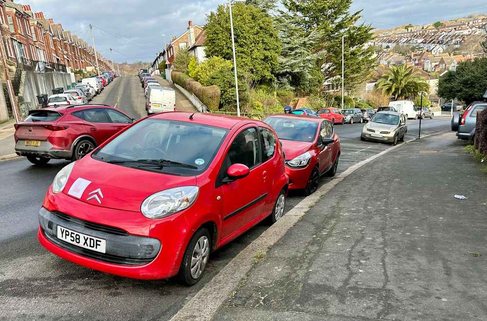 Photograph of YP58 XDF - a Red Citroen C1 parked in Hollingdean by a non-resident, and potentially abandoned. The third of twenty photographs supplied by the residents of Hollingdean.