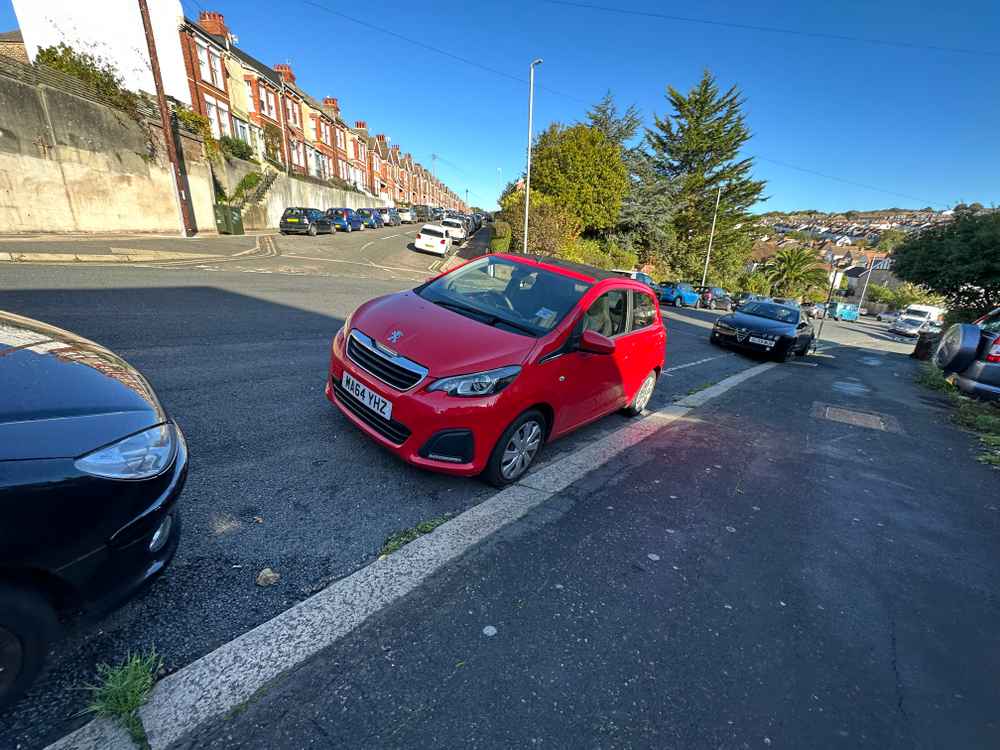 Photograph of MA64 YHZ - a Red Peugeot 108 parked in Hollingdean by a non-resident who uses the local area as part of their Brighton commute. The second of six photographs supplied by the residents of Hollingdean.