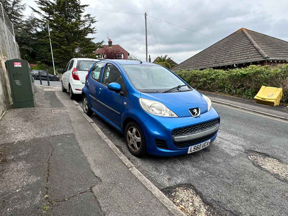 Photograph of LS60 UCA - a Blue Peugeot 107 parked in Hollingdean by a non-resident. The eleventh of thirteen photographs supplied by the residents of Hollingdean.