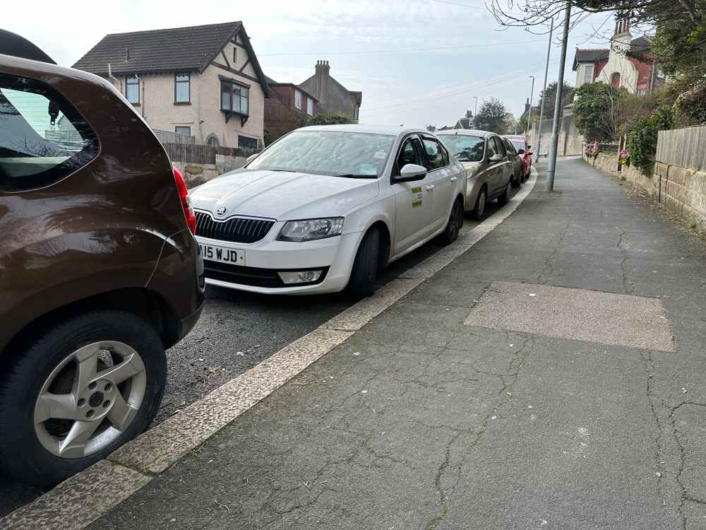Photograph of DA15 WJD - a White Skoda Octavia taxi parked in Hollingdean by a non-resident. The sixth of ten photographs supplied by the residents of Hollingdean.