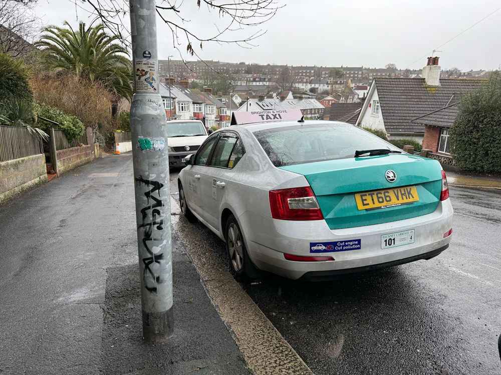 Photograph of ET66 VHK - a White Skoda Octavia taxi parked in Hollingdean. The third of four photographs supplied by the residents of Hollingdean.