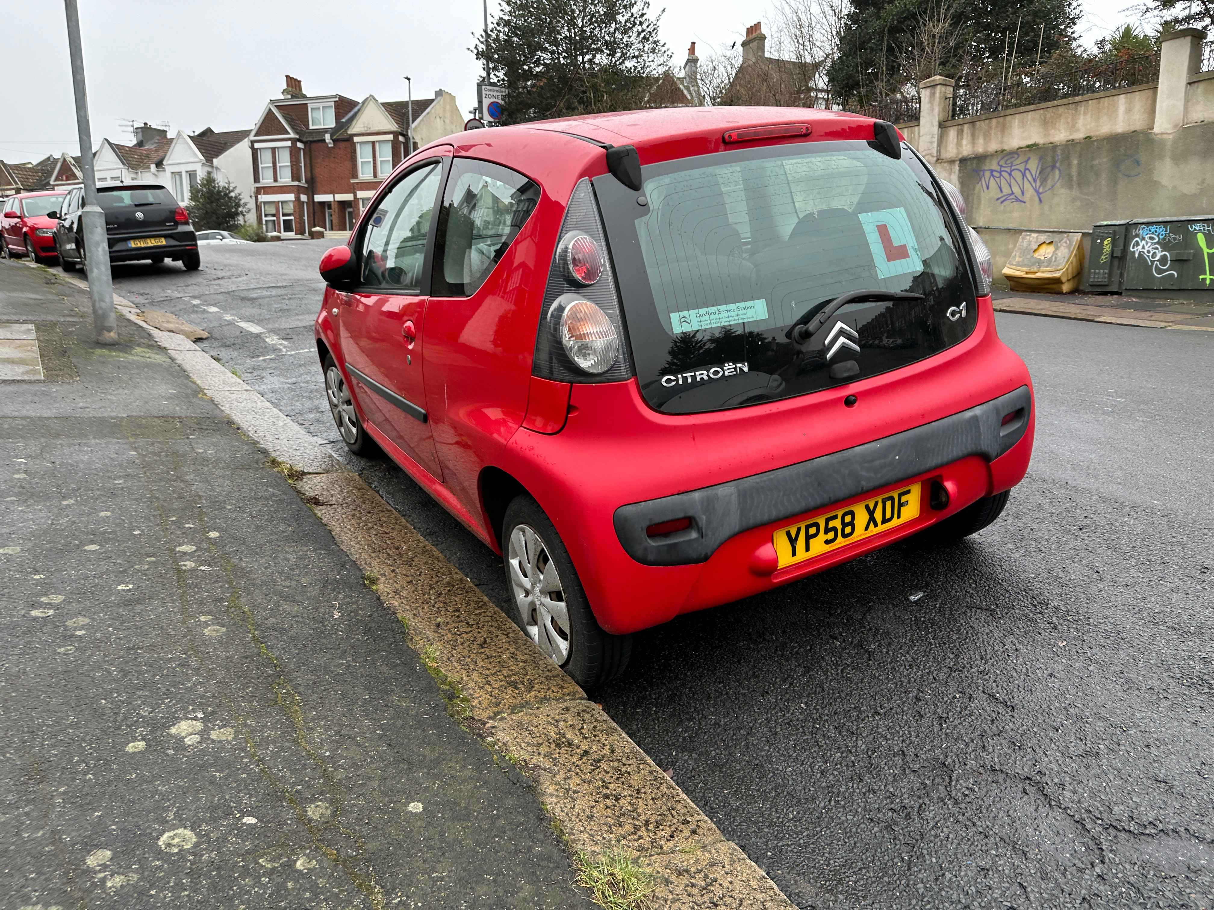 Photograph of YP58 XDF - a Red Citroen C1 parked in Hollingdean by a non-resident, and potentially abandoned. The fourth of five photographs supplied by the residents of Hollingdean.