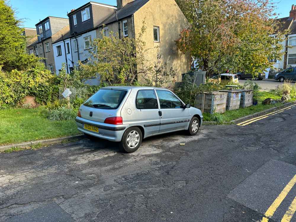 Photograph of HK52 KNZ - a Silver Peugeot 106 parked in Hollingdean by a non-resident, and potentially abandoned. The third of three photographs supplied by the residents of Hollingdean.