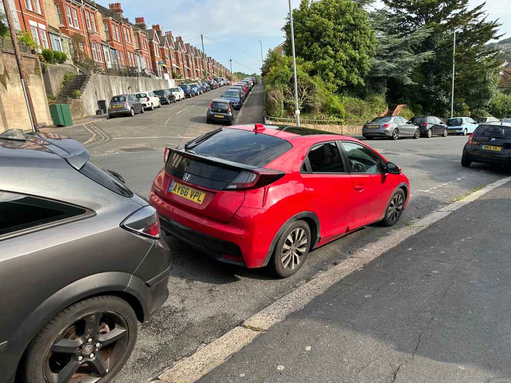 Photograph of AY66 VPL - a Red Honda Civic parked in Hollingdean by a non-resident. The first of five photographs supplied by the residents of Hollingdean.