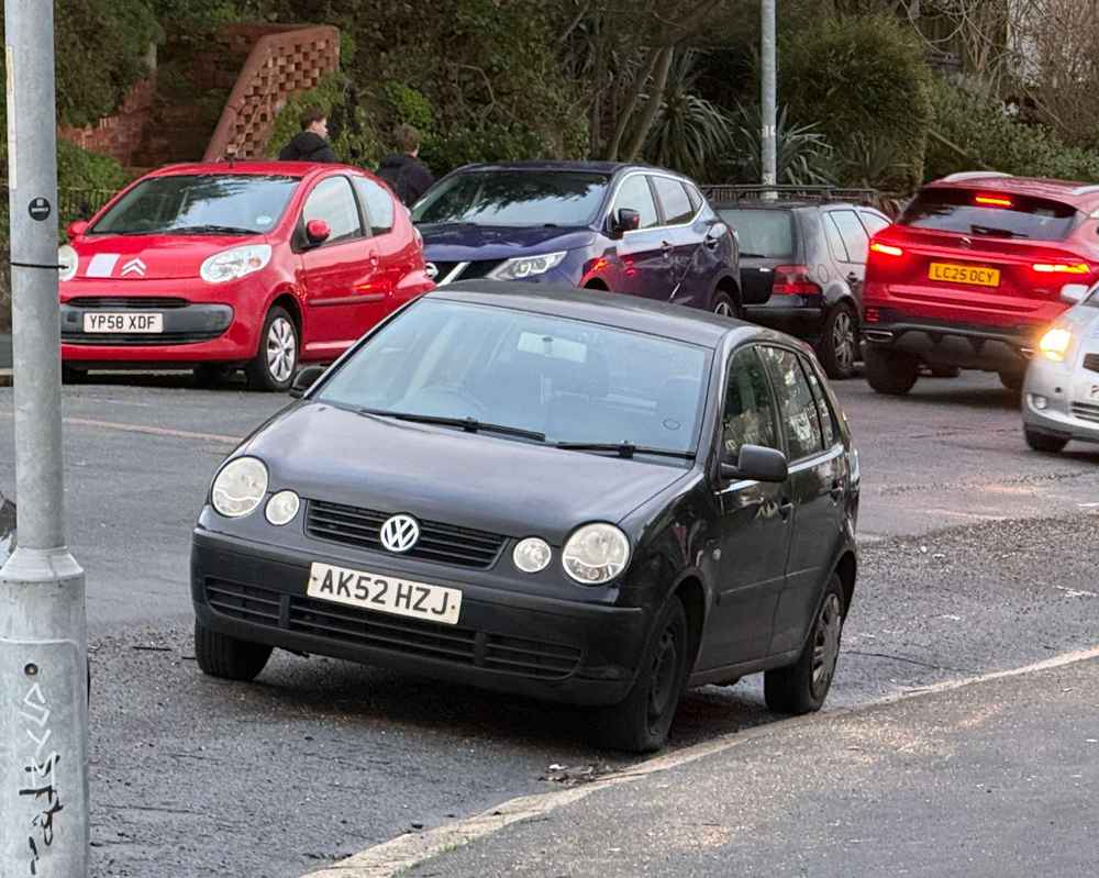 Photograph of AK52 HZJ - a Black Volkswagen Polo parked in Hollingdean by a non-resident, and potentially abandoned. The second of four photographs supplied by the residents of Hollingdean.