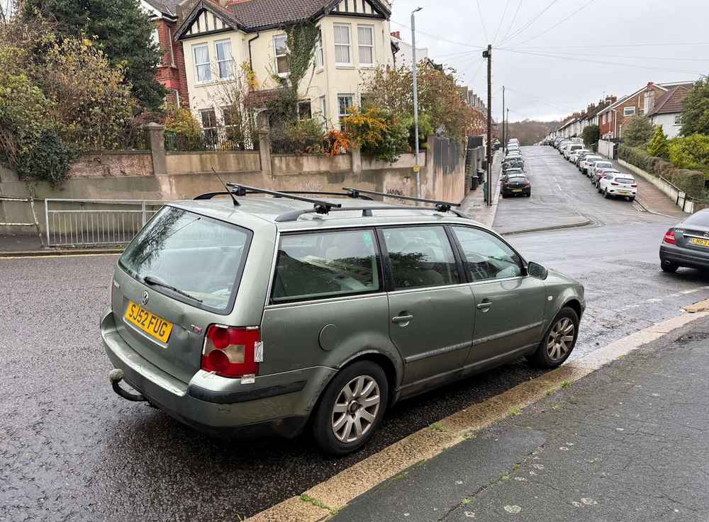 Photograph of SJ52 FUG - a Green Volkswagen Passat parked in Hollingdean by a non-resident, and potentially abandoned. The first of three photographs supplied by the residents of Hollingdean.