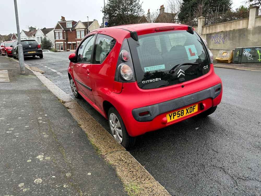 Photograph of YP58 XDF - a Red Citroen C1 parked in Hollingdean by a non-resident, and potentially abandoned. The fourth of twenty photographs supplied by the residents of Hollingdean.
