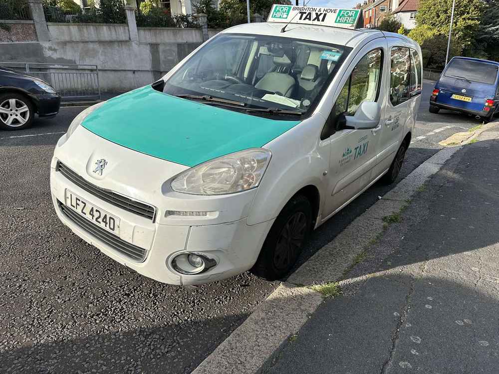 Photograph of LFZ 4240 - a White Peugeot Partner taxi parked in Hollingdean by a non-resident. The first of three photographs supplied by the residents of Hollingdean.