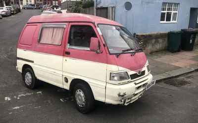 W844 RHR, a Pink Daihatsu Hijet parked in Hollingdean