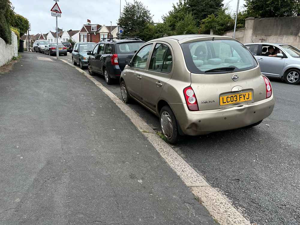 Photograph of LC03 FYJ - a Gold Nissan Micra parked in Hollingdean by a non-resident, and potentially abandoned. The twentieth of twenty-eight photographs supplied by the residents of Hollingdean.
