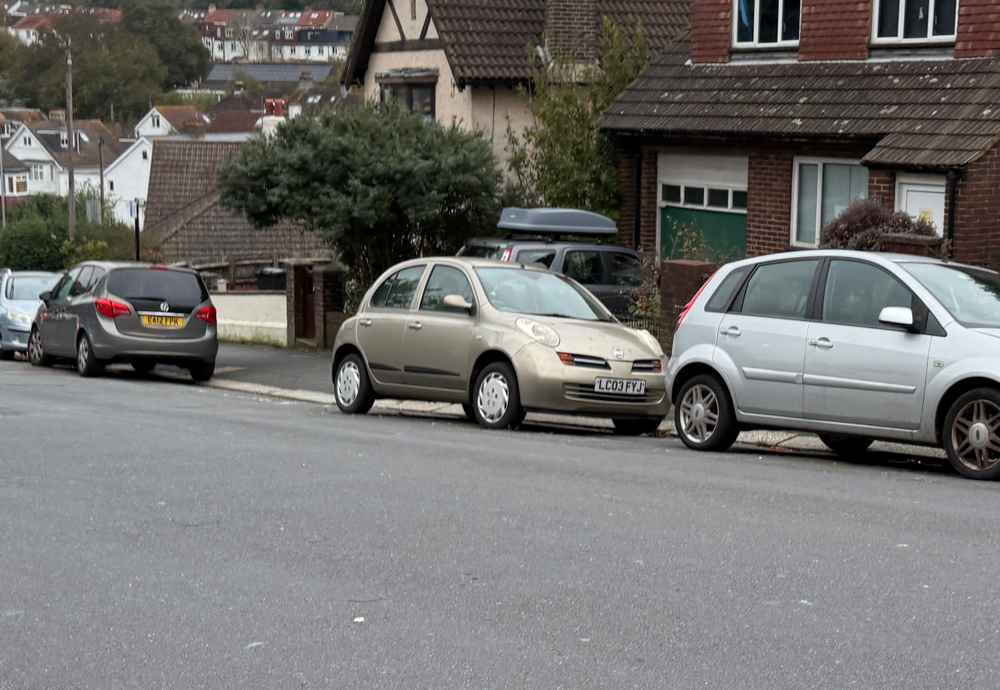 Photograph of LC03 FYJ - a Gold Nissan Micra parked in Hollingdean by a non-resident, and potentially abandoned. The twenty-second of twenty-seven photographs supplied by the residents of Hollingdean.