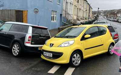 AP07 OZS, a Yellow Peugeot 107 parked in Hollingdean
