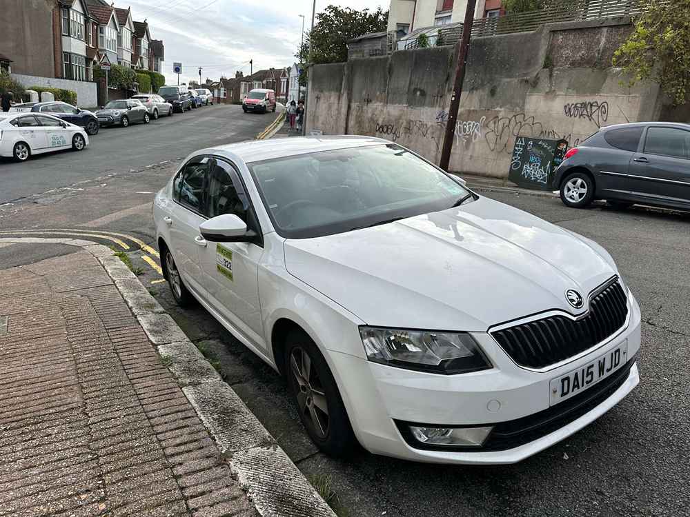 Photograph of DA15 WJD - a White Skoda Octavia taxi parked in Hollingdean by a non-resident. The third of nineteen photographs supplied by the residents of Hollingdean.