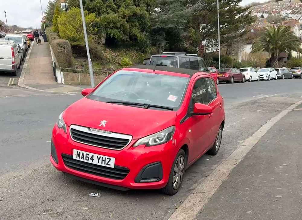 Photograph of MA64 YHZ - a Red Peugeot 108 parked in Hollingdean by a non-resident who uses the local area as part of their Brighton commute. The eleventh of fourteen photographs supplied by the residents of Hollingdean.