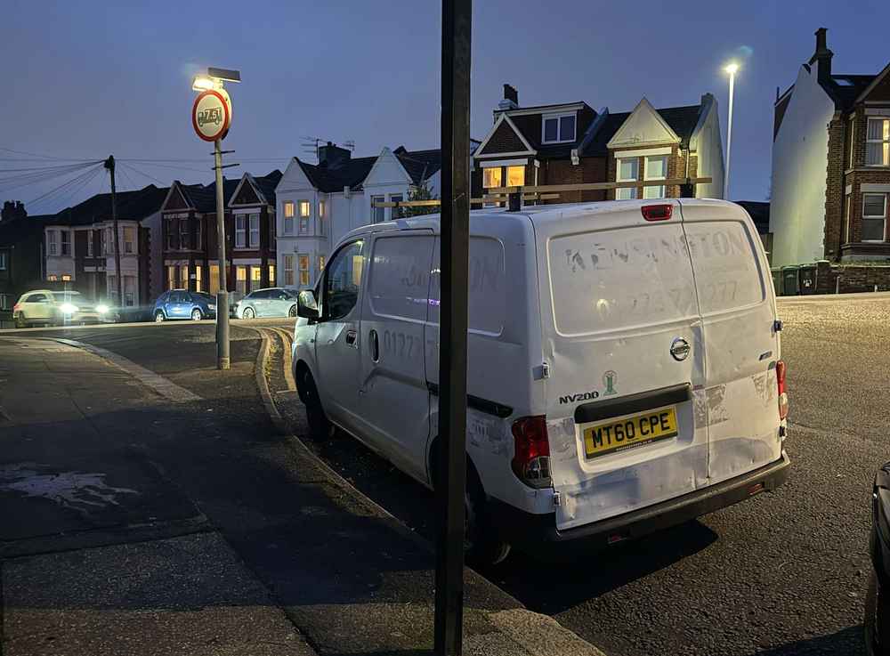 Photograph of MT60 CPE - a White Nissan NV200 parked in Hollingdean by a non-resident, and potentially abandoned. The fourteenth of fourteen photographs supplied by the residents of Hollingdean.