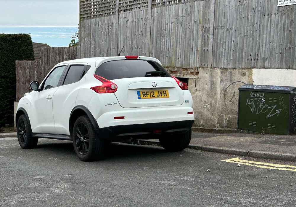 Photograph of RF12 JVH - a White Nissan Juke parked in Hollingdean by a non-resident who uses the local area as part of their Brighton commute. The seventh of twenty-five photographs supplied by the residents of Hollingdean.