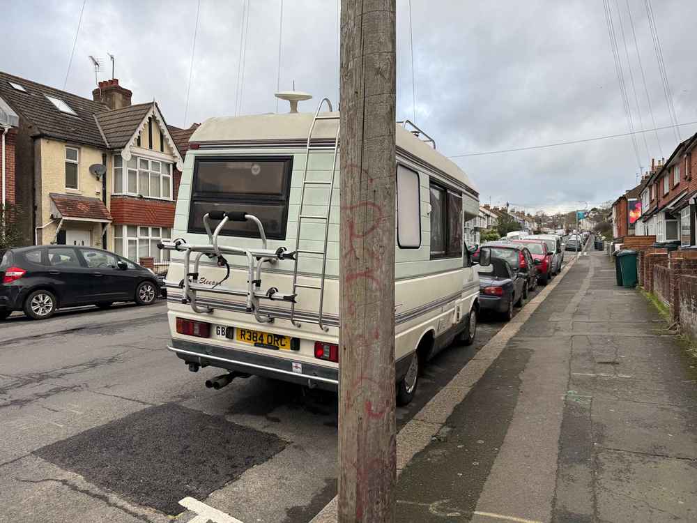 Photograph of R384 ORC - a Beige Volkswagen Transporter camper van parked in Hollingdean by a non-resident, and potentially abandoned. The fifteenth of fifteen photographs supplied by the residents of Hollingdean.