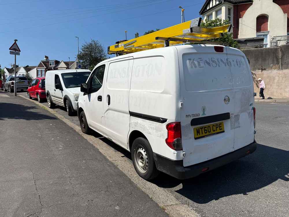Photograph of MT60 CPE - a White Nissan NV200 parked in Hollingdean by a non-resident, and potentially abandoned. The fifth of fourteen photographs supplied by the residents of Hollingdean.