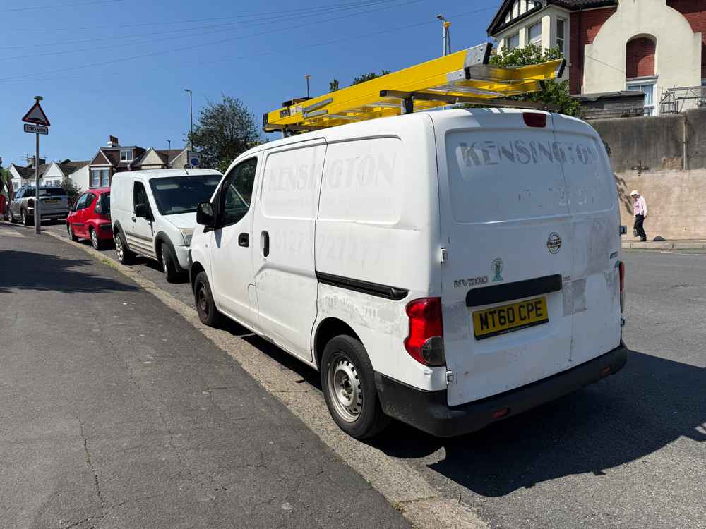 Photograph of MT60 CPE - a White Nissan NV200 parked in Hollingdean by a non-resident, and potentially abandoned. The fifth of five photographs supplied by the residents of Hollingdean.