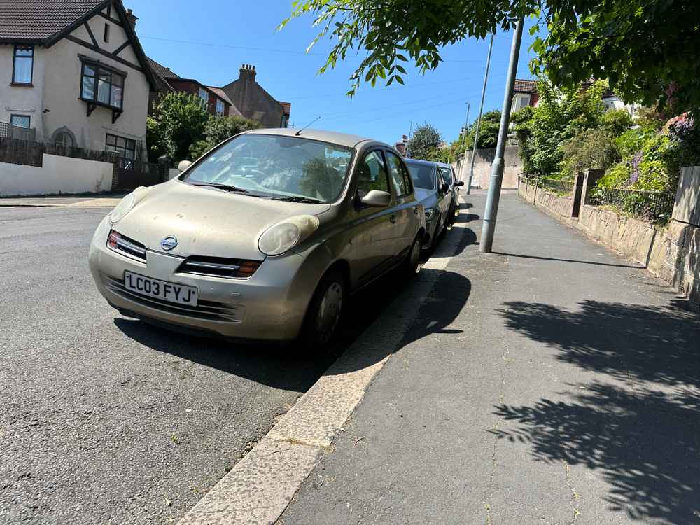 Photograph of LC03 FYJ - a Gold Nissan Micra parked in Hollingdean by a non-resident, and potentially abandoned. The seventeenth of twenty-three photographs supplied by the residents of Hollingdean.