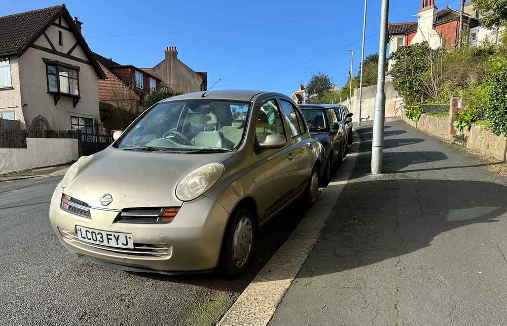 Photograph of LC03 FYJ - a Gold Nissan Micra parked in Hollingdean by a non-resident, and potentially abandoned. The fifteenth of twenty-three photographs supplied by the residents of Hollingdean.