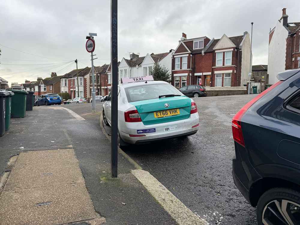 Photograph of ET66 VHK - a White Skoda Octavia taxi parked in Hollingdean. The fourth of four photographs supplied by the residents of Hollingdean.