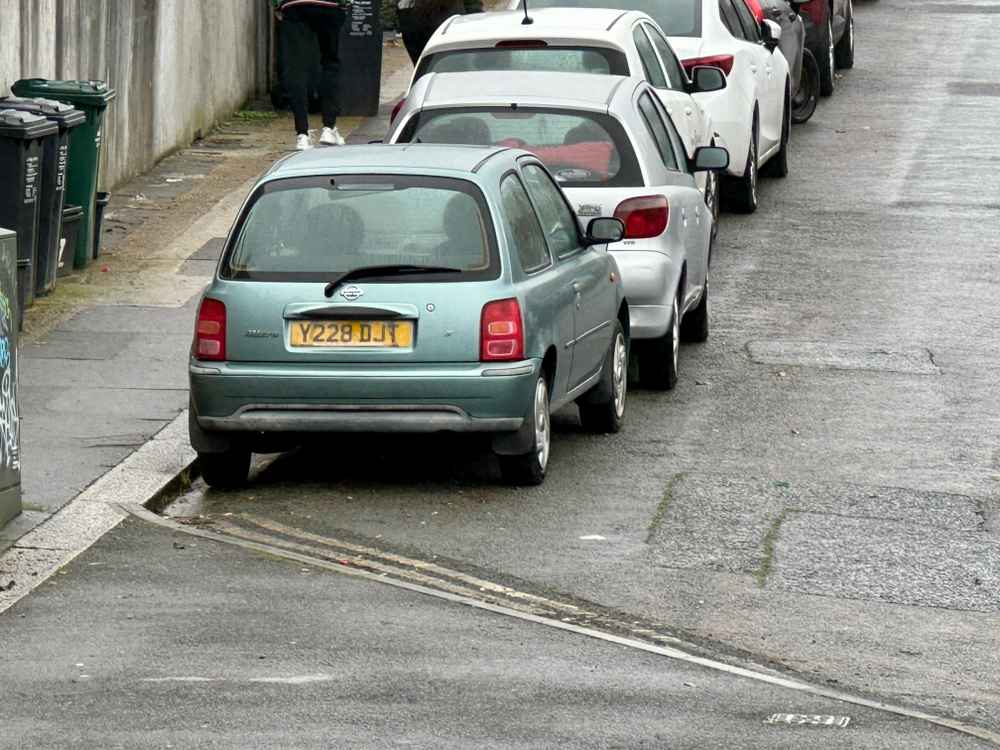 Photograph of Y228 DJT - a Green Nissan Micra parked in Hollingdean by a non-resident, and potentially abandoned. The first of four photographs supplied by the residents of Hollingdean.