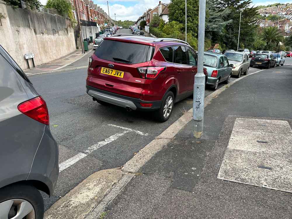 Photograph of EA67 JVX - a Red Ford Kuga parked in Hollingdean by a non-resident. The third of three photographs supplied by the residents of Hollingdean.