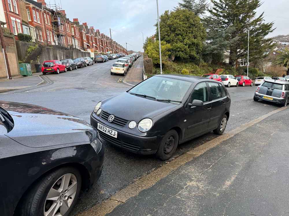 Photograph of AK52 HZJ - a Black Volkswagen Polo parked in Hollingdean by a non-resident, and potentially abandoned. The third of four photographs supplied by the residents of Hollingdean.