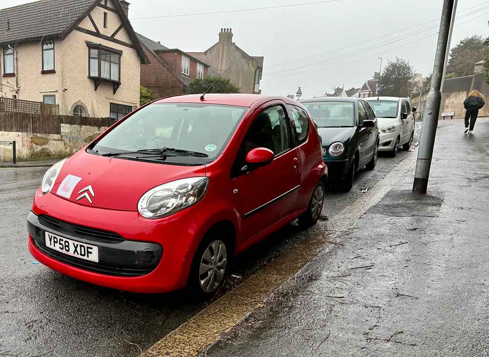 Photograph of YP58 XDF - a Red Citroen C1 parked in Hollingdean by a non-resident, and potentially abandoned. The second of seven photographs supplied by the residents of Hollingdean.