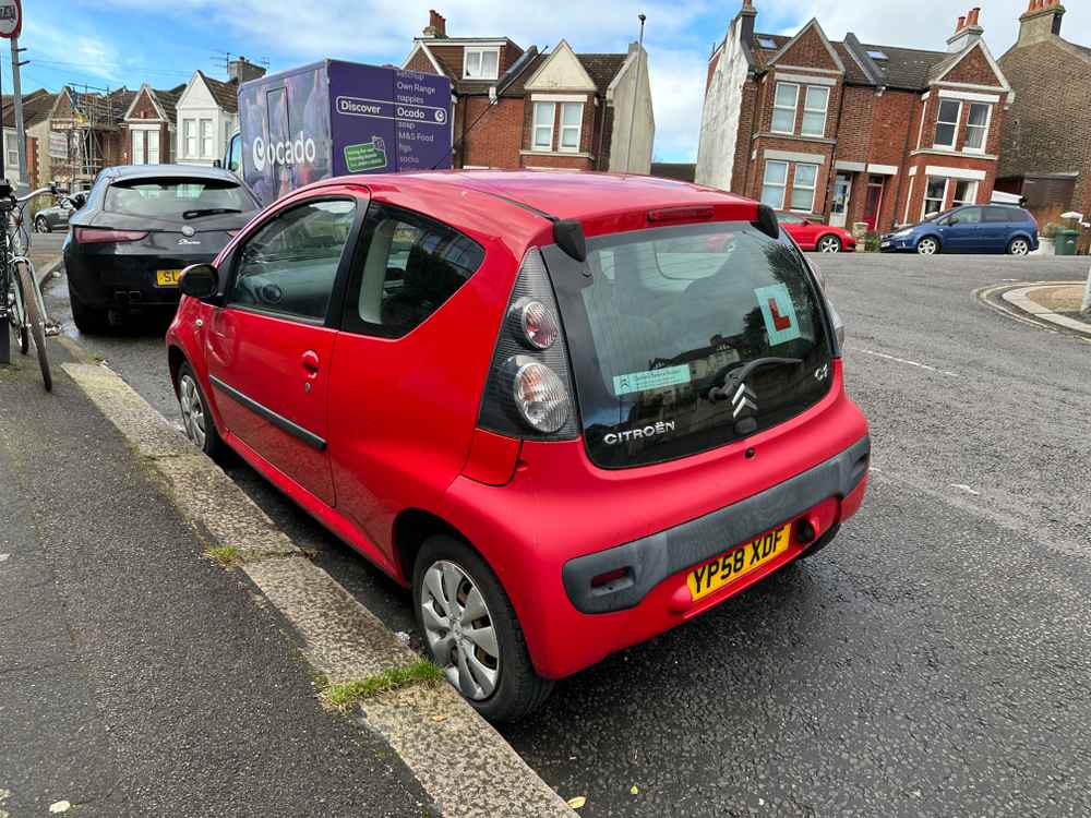 Photograph of YP58 XDF - a Red Citroen C1 parked in Hollingdean by a non-resident, and potentially abandoned. The sixth of seven photographs supplied by the residents of Hollingdean.
