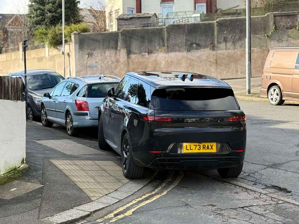 Photograph of LL73 RAX - a Black Land Rover Range Rover parked in Hollingdean by a non-resident. The first of two photographs supplied by the residents of Hollingdean.