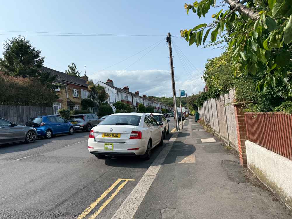 Photograph of DA15 WJD - a White Skoda Octavia taxi parked in Hollingdean by a non-resident. The eighteenth of eighteen photographs supplied by the residents of Hollingdean.