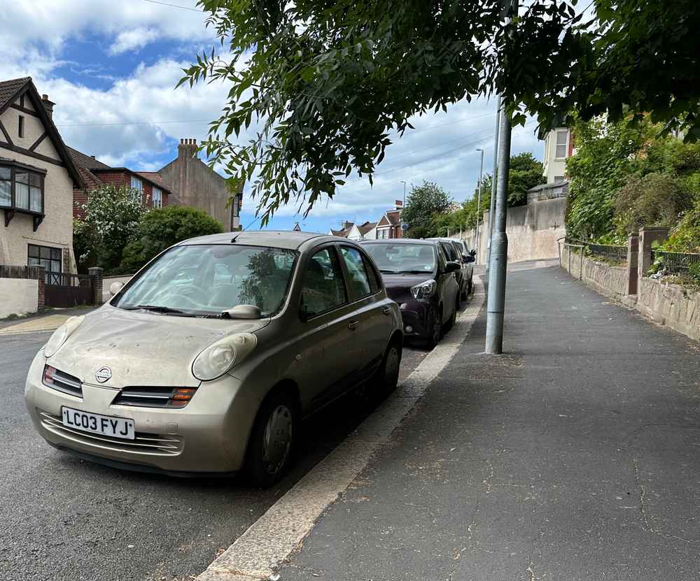 Photograph of LC03 FYJ - a Gold Nissan Micra parked in Hollingdean by a non-resident, and potentially abandoned. The eighteenth of twenty-three photographs supplied by the residents of Hollingdean.