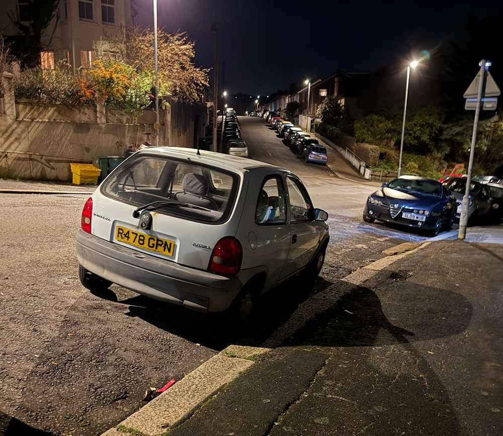 Photograph of R478 GPN - a White Vauxhall Corsa parked in Hollingdean by a non-resident, and potentially abandoned. The third of five photographs supplied by the residents of Hollingdean.