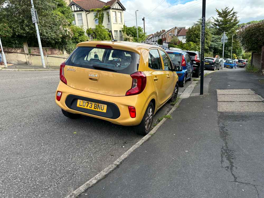 Photograph of LD73 BNU - a Yellow Kia Picanto parked in Hollingdean by a non-resident. The second of four photographs supplied by the residents of Hollingdean.